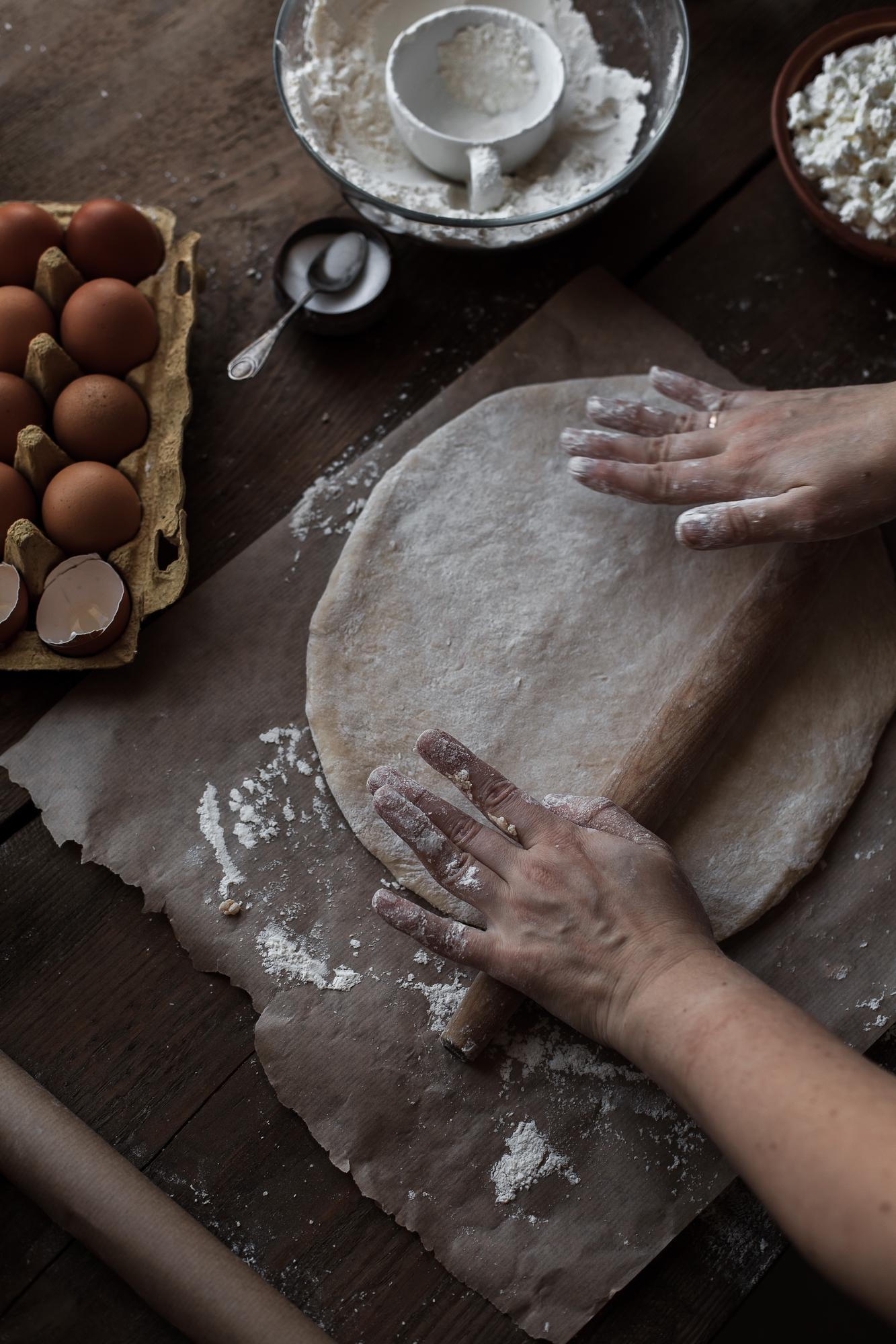 hands kneading dough in rustic kitchen